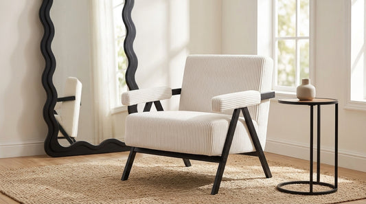 Aster white corduroy armchair styled in a bright living space with plants and natural light