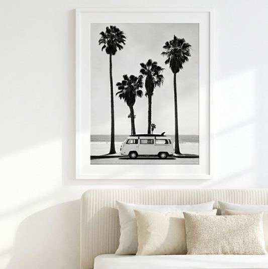 Venice Drive black and white palms and vintage camper van coastal wall art framed above a bed