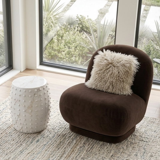 Atelier Noir black studded side table in gloss stone resin, barrel-shaped form with all-over raised circular studs on white background