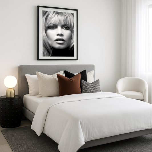 Bardot black and white fashion portrait wall art in a black frame above a styled bed