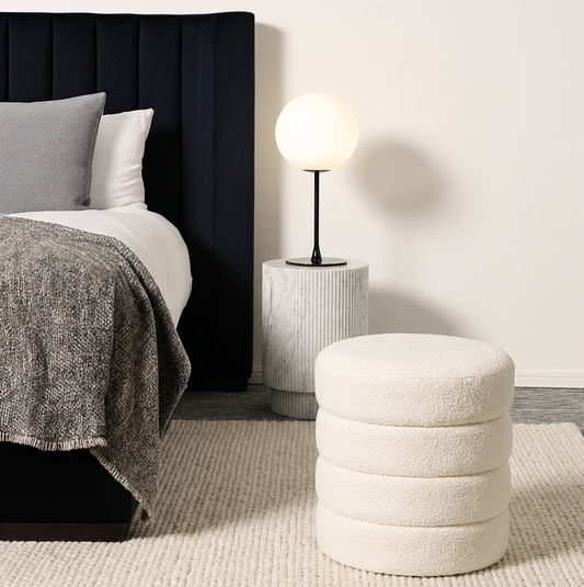 Cleo white boucle ottoman styled in a warm bedroom corner with sheer curtains and timber bedside table