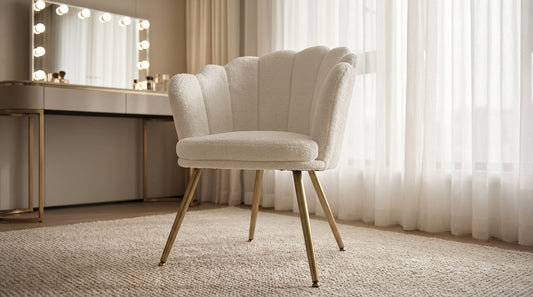 Whitearmchair in a room with a vanity table and mirror.