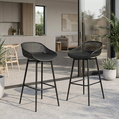 Two black bar stools with woven seats in a modern outdoor setting.