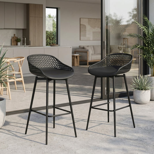 Two black bar stools with woven seats in a modern outdoor setting.
