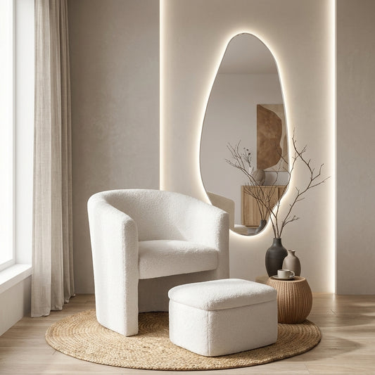 Sorrento white boucle armchair with pull-out storage ottoman styled in a bedroom with oval mirror, pampas grass and neutral tones