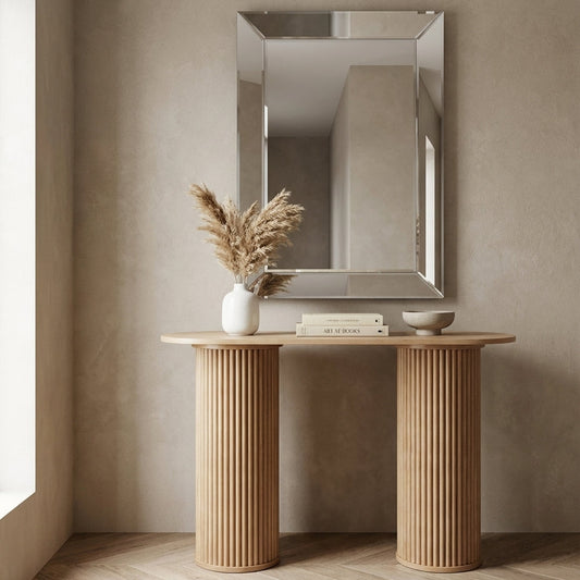 Wooden console table with decorative items against a beige wall