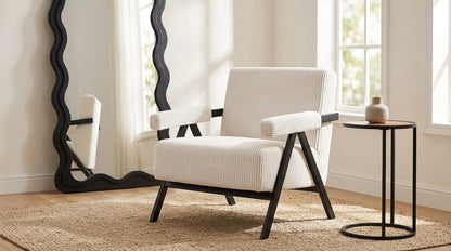Aster white corduroy armchair styled in a bright living space with plants and natural light