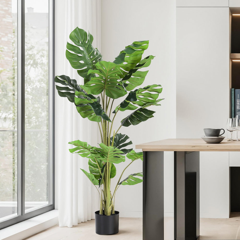 140cm faux monstera tree with split-leaf green foliage in a weighted cement pot