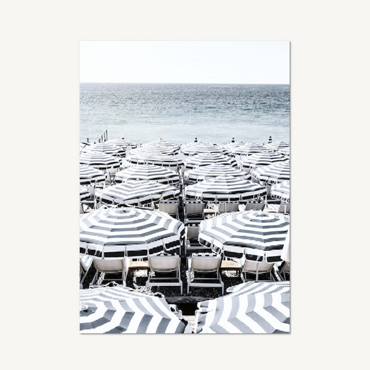 Capri wall art — dense rows of striped beach umbrellas and white chairs viewed from above with the grey-blue Mediterranean Sea beyond
