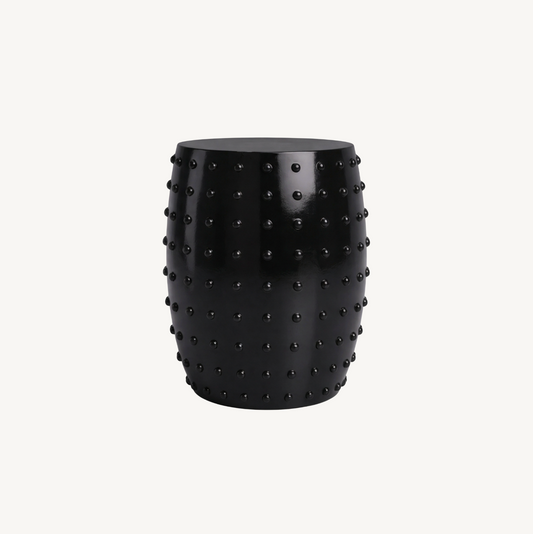 Atelier Noir black studded side table, white background product shot showing barrel form with all-over raised circular studs