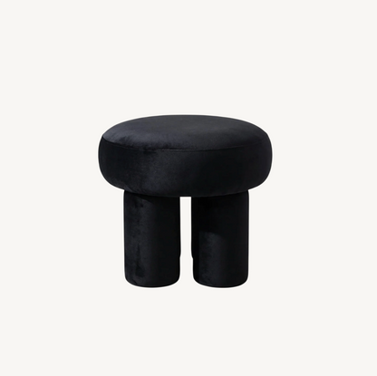 Bentley velvet ottoman in black, sculptural low-profile form with soft velvet upholstery