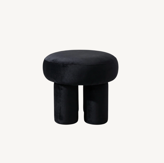 Bentley velvet ottoman in black, sculptural low-profile form with soft velvet upholstery