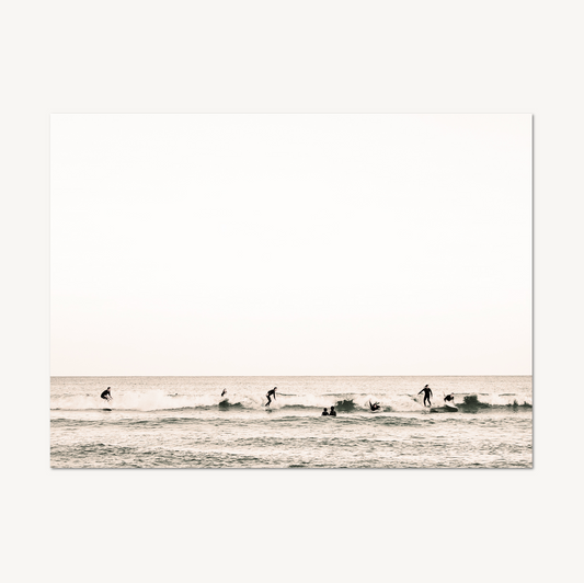 Bondi Surf wall art — surfers riding small waves in soft sepia and blush tones, horizontal coastal composition