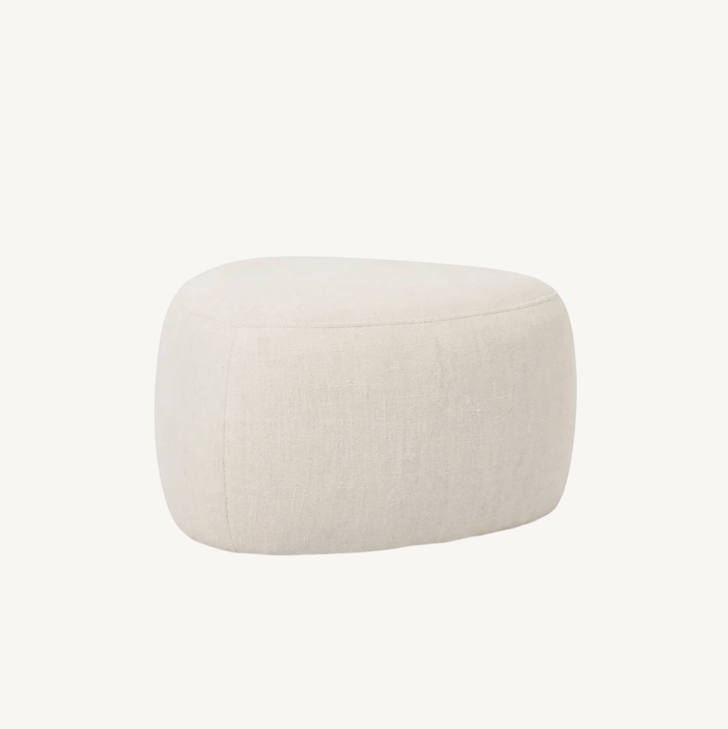 Cove pebble ottoman in vanilla, organic rounded silhouette in light neutral fabric styled beside a wire accent chair on a striped rug