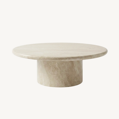 Nobu natural stone round coffee table, white background product shot showing warm travertine-look finish and sculptural pedestal base