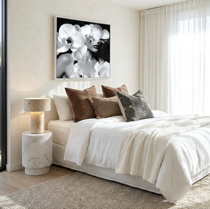 Sapphire black and white portrait of a woman half-obscured by sculptural white orchids wall art