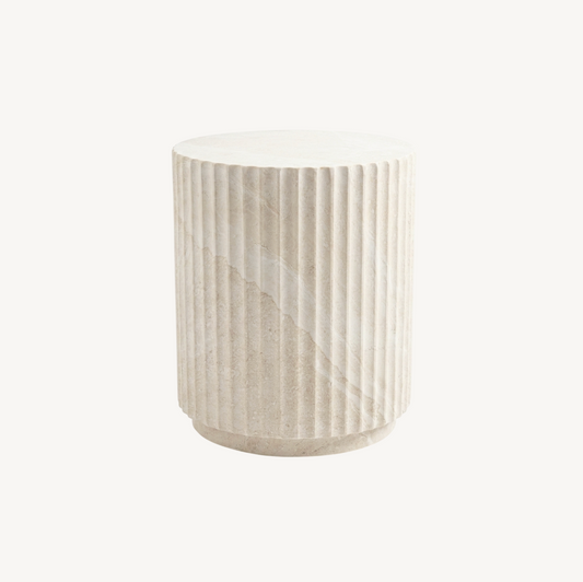 Vera fluted stone side table in matte natural stone, white background product shot showing cylindrical fluted form and stepped base