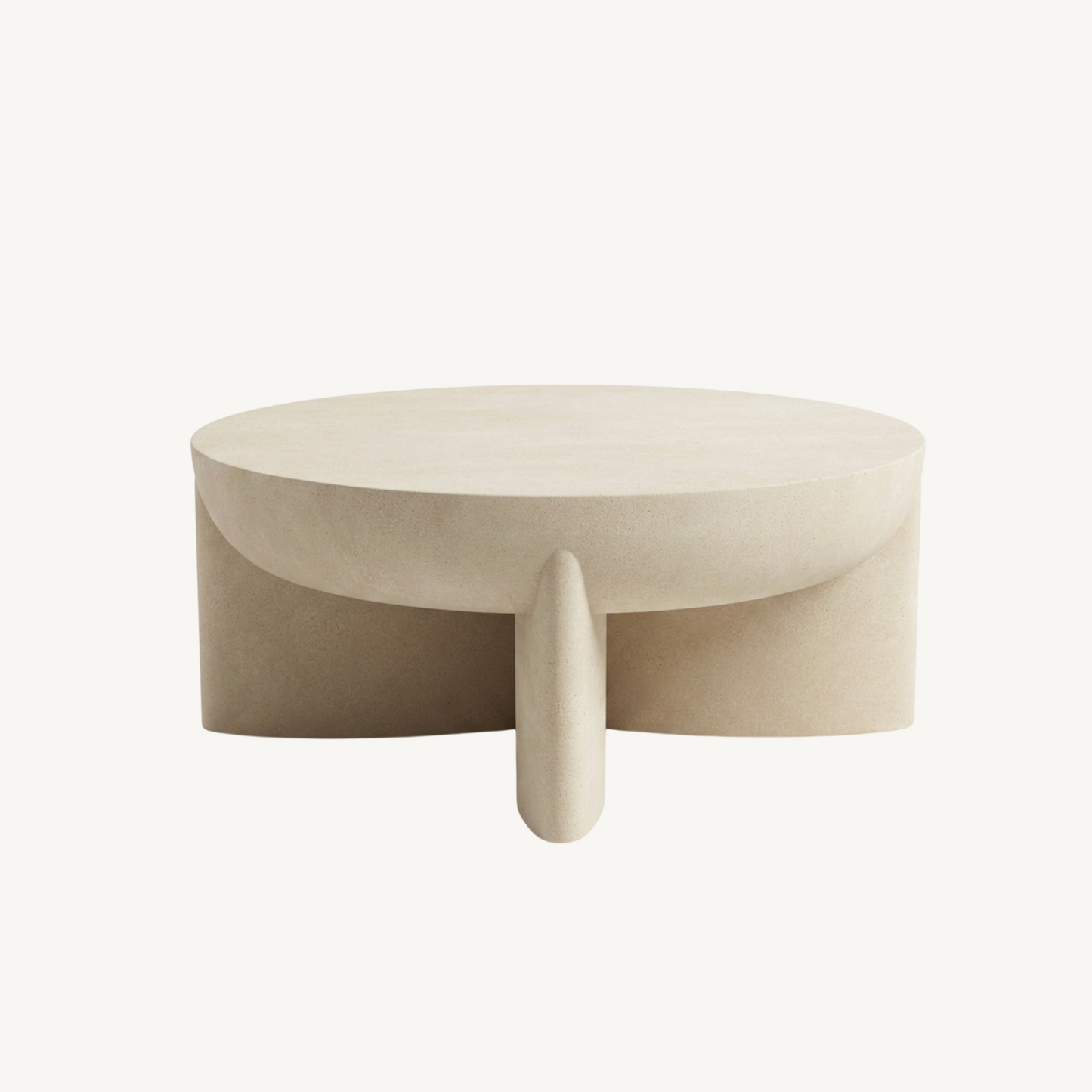 Zelda sculptural stone coffee table in sand textured finish, white background product shot showing bowl-style top and three angled architectural legs